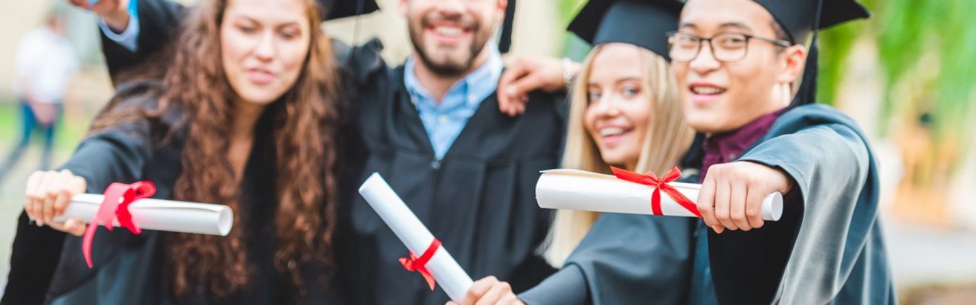 portrait-of-happy-multiracial-graduates-with-diplomas-on-street.jpg